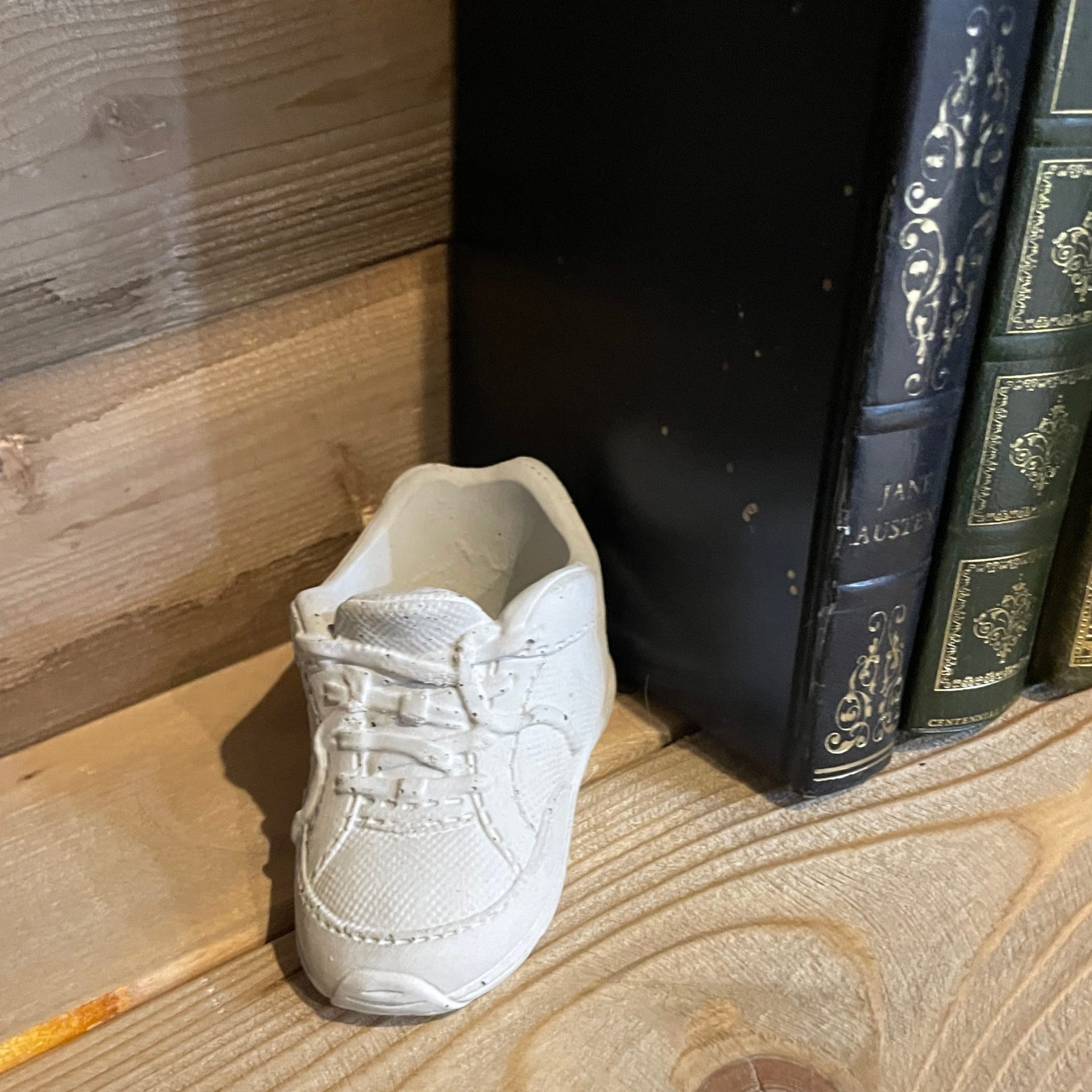 棚にディスプレイされてるセメント製のクツ